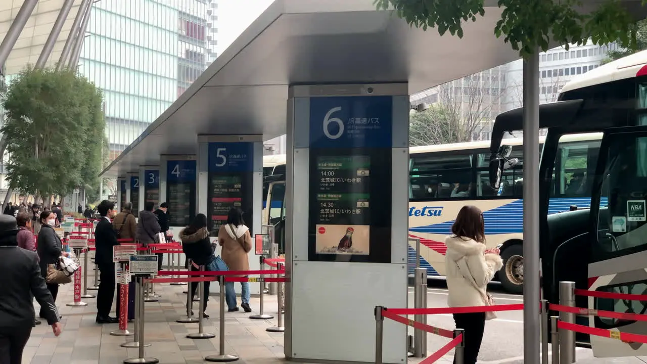 People waiting and lineup at bus stop terminal front to Yaesu Central entrance-exit of Tokyo Station