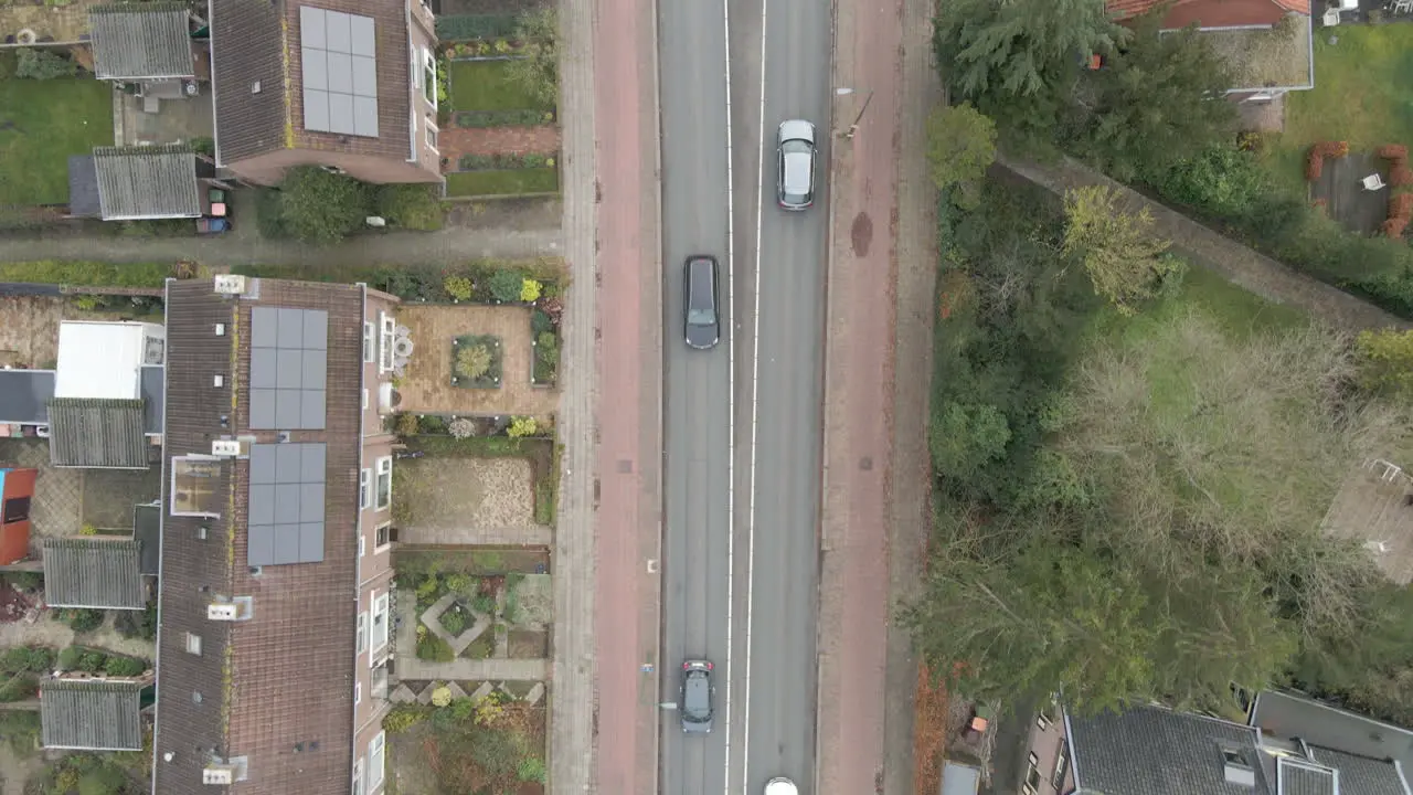 Top down aerial of cars driving over road