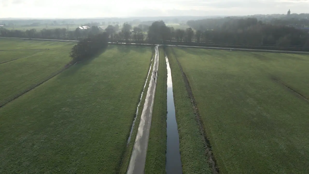 Aerial of cyclists on a small road in rural Holland