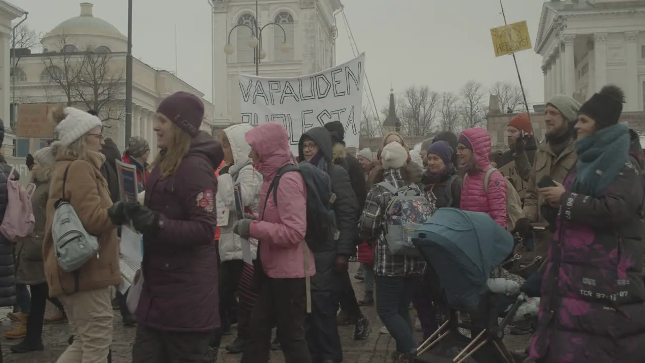 Huge crowd of protesters walk during a peaceful protest on a cold winter day