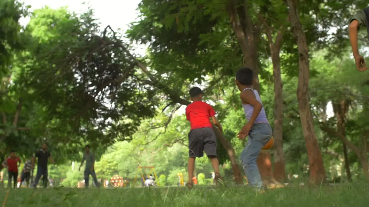 Indian Children Playing Football in a Park