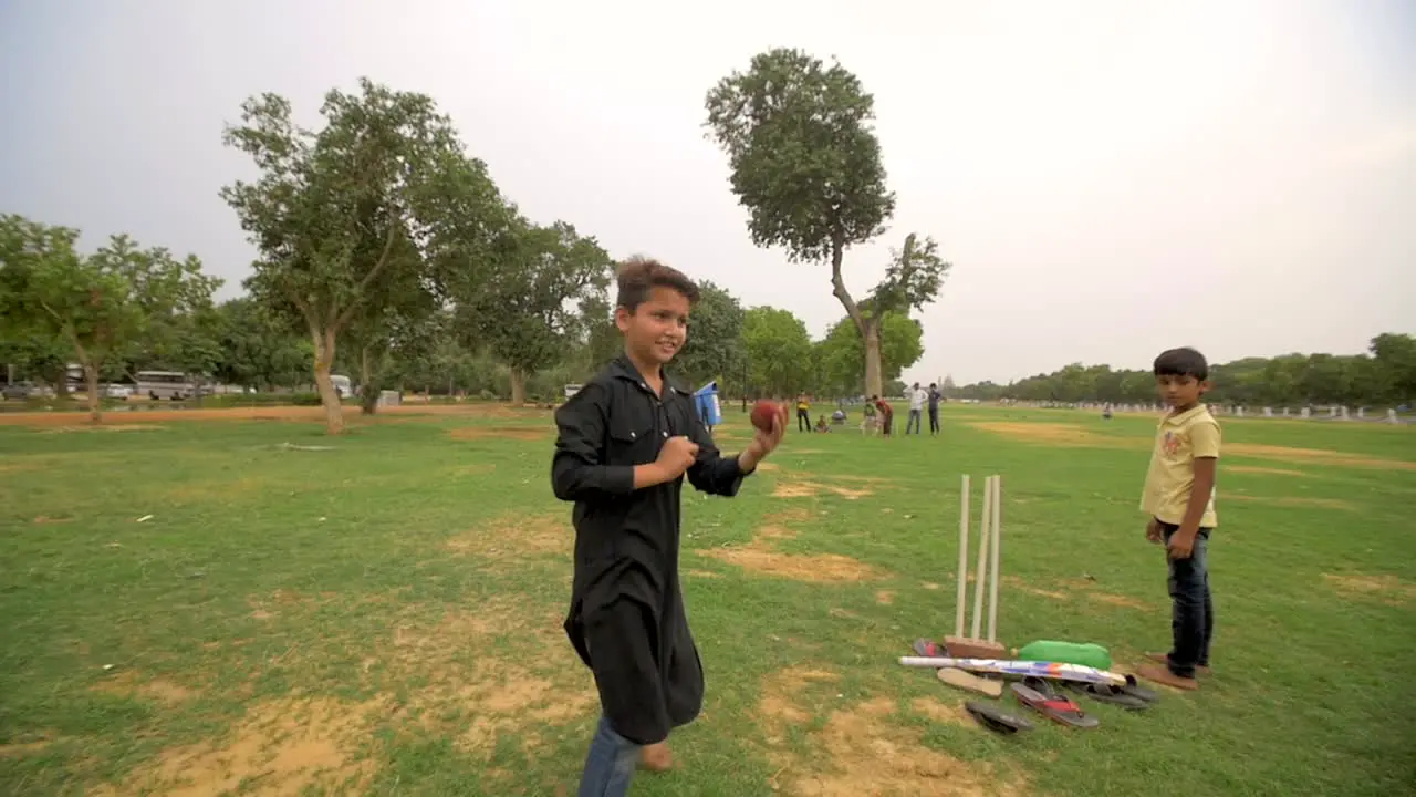 Children Bowling in Cricket Game