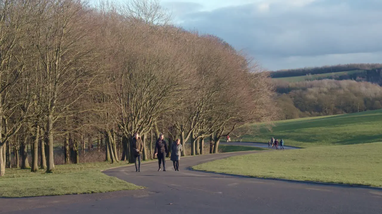 People walking in the park on a bright cold winters day at temple Newsam Leeds England