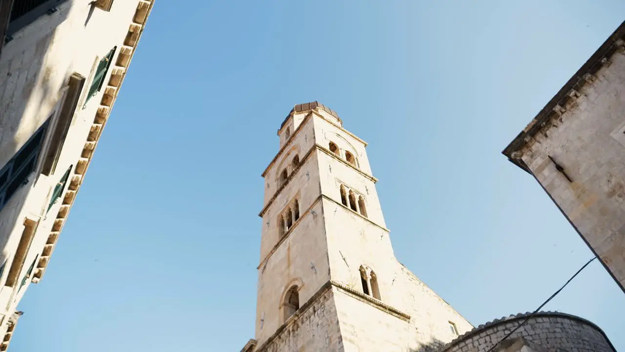 Dubrovnik clock tower and buildings of the old town against the backdrop of a blue sky