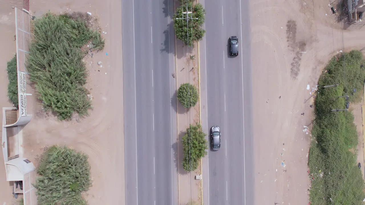 Beautiful aerial drone shot of the "Panamericana Norte" highway in northern Peru with passing cars and trucks