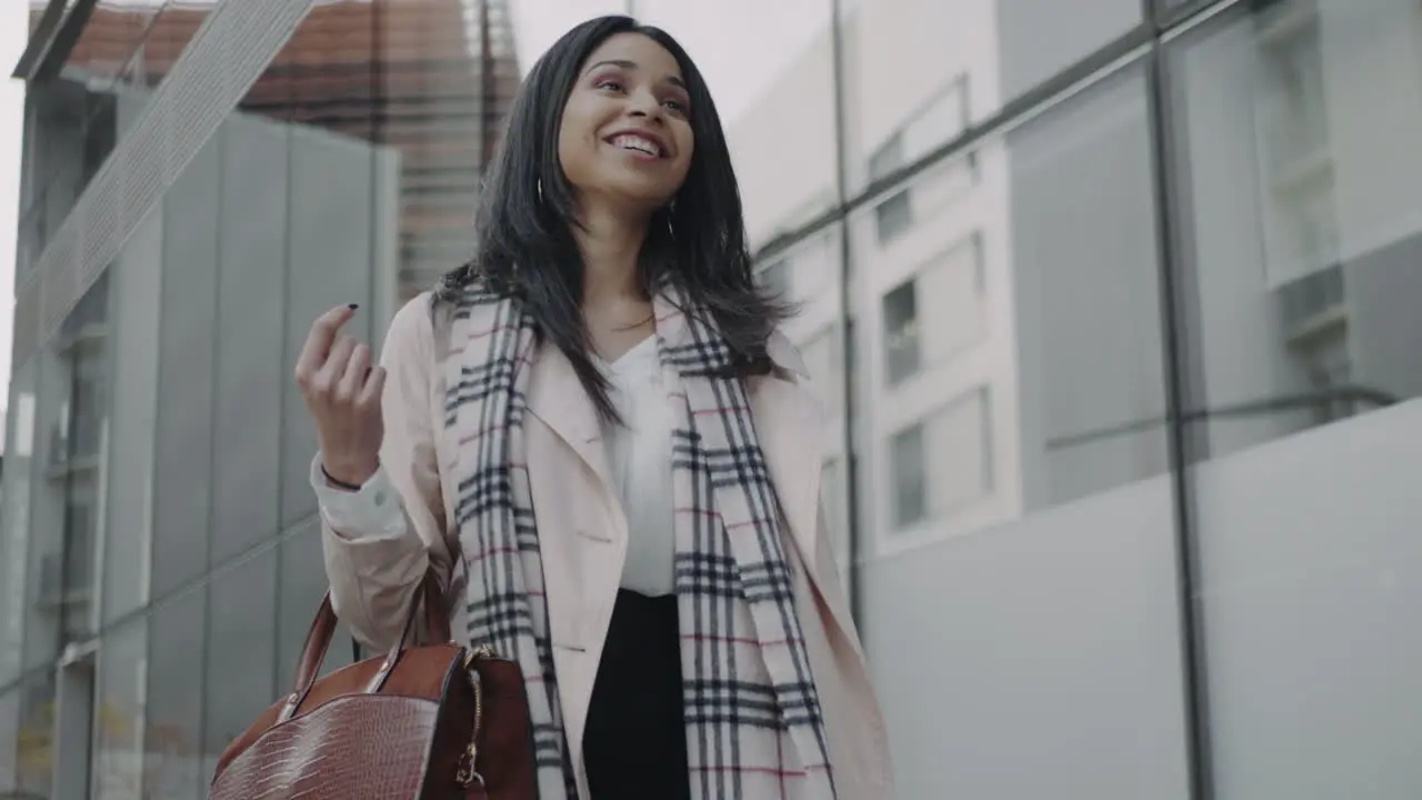 Businesswoman walking on street Smiling executive wearing stylish coat outdoors