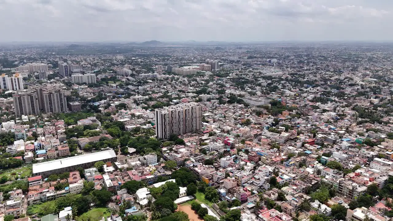 Top shot of traditional Indian houses and tall apartments at Chennai with cityscape at background in India