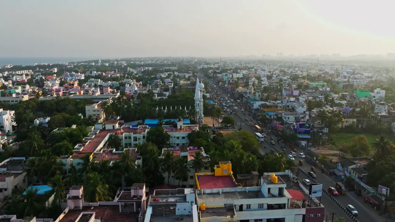 Parallax drone shot of city of Chennai with busy roads during afternoon in India