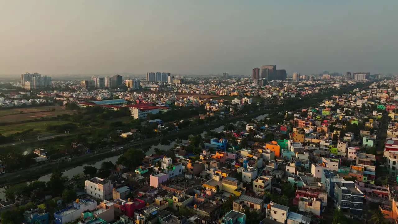 Forward drone shot of a city of Chennai with a lake during sunset in India