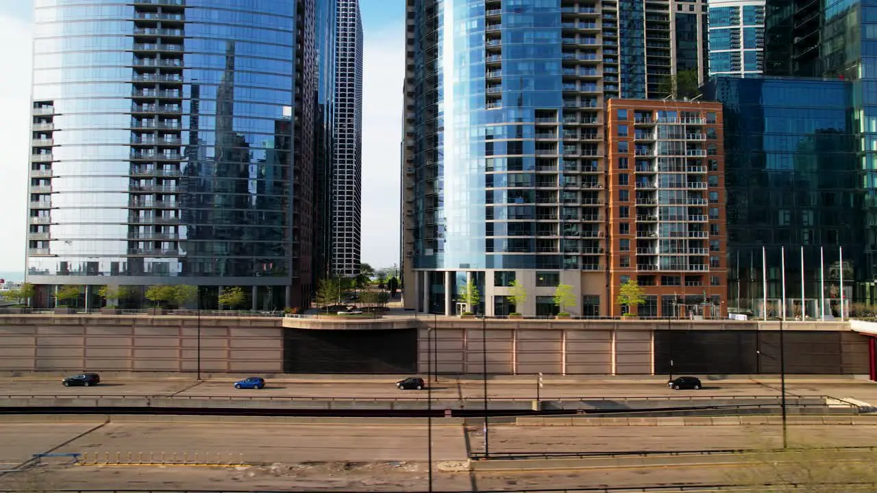 Cars Passing By Luxury Glass Skyscrapers In Downtown Cityscape