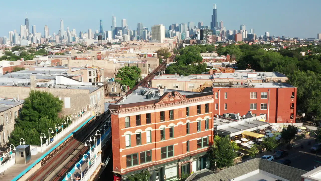 Apartment buildings with a crossing railway and a big city skyline Drone shot