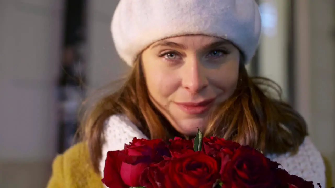 Portrait of beautiful woman with a bunch of red roses