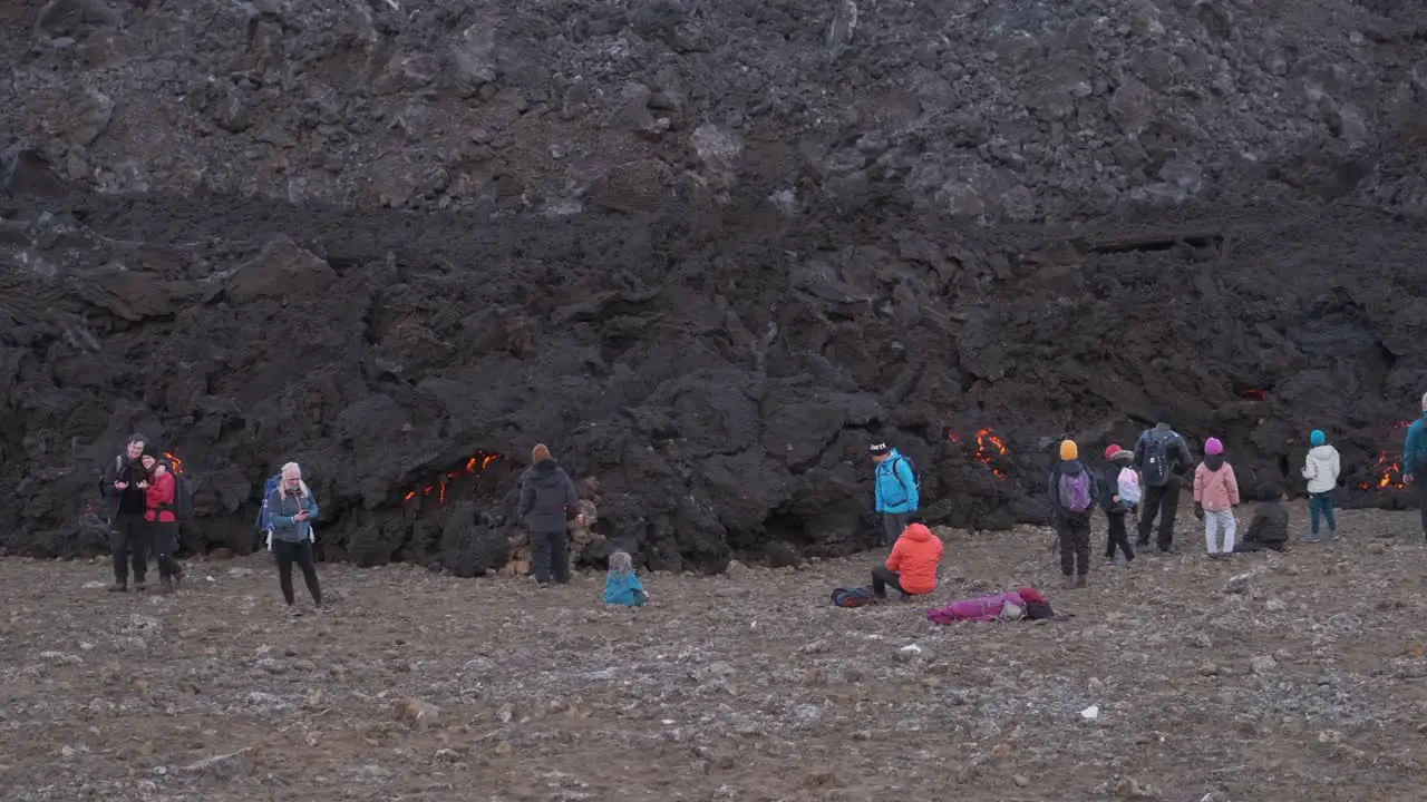 People next cooling lava after eruption Panning