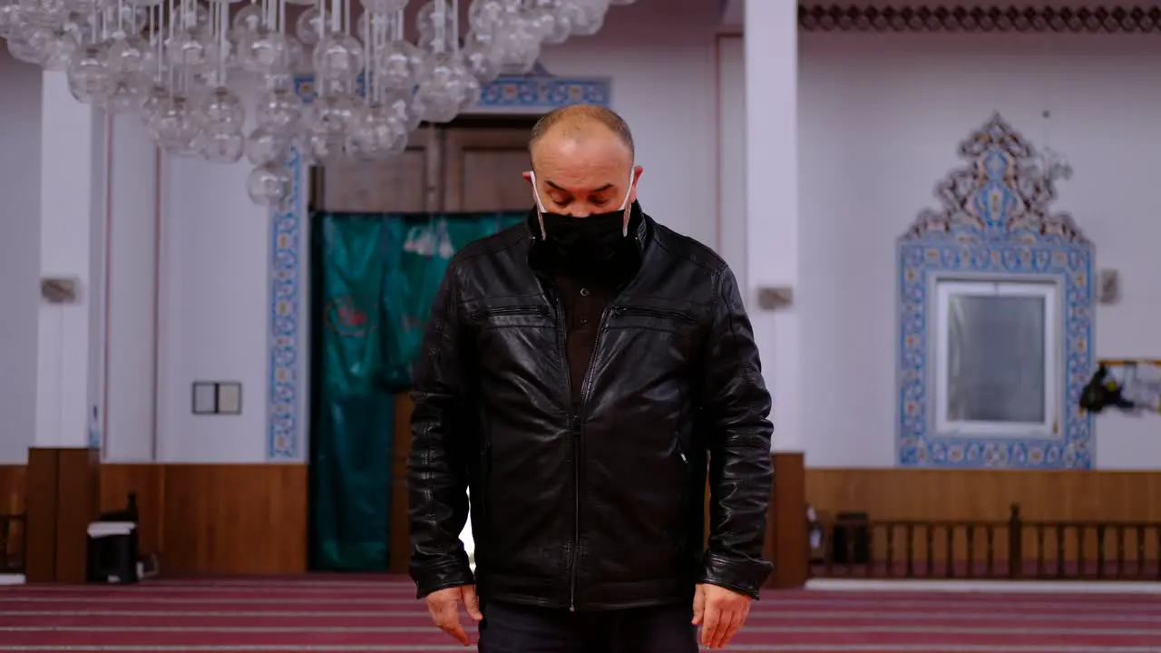 Older Man Prays In A Mask In A Mosque 1