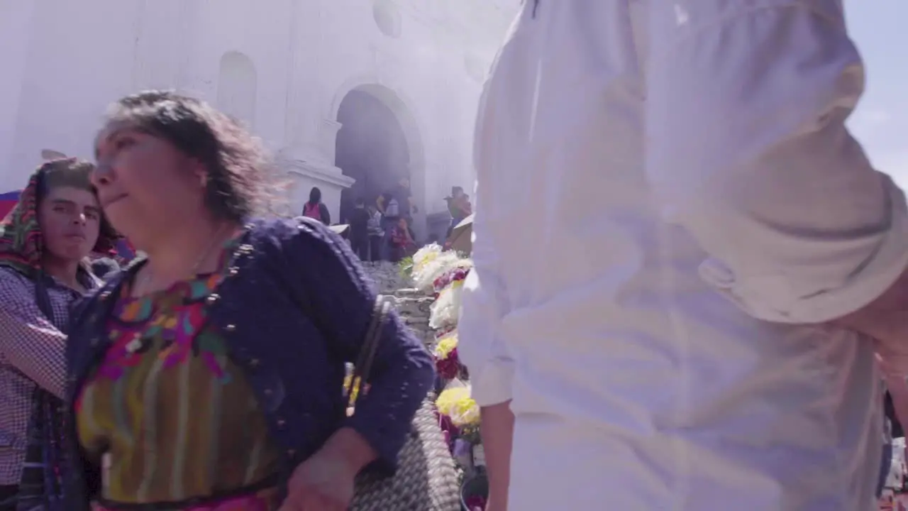 Old colonial church in Chichi Guatemala during daytime people walking in slow motion