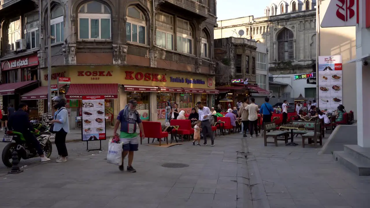 Scene of people walking and having lunch at restaurants in Fatih district Istanbul Turkey