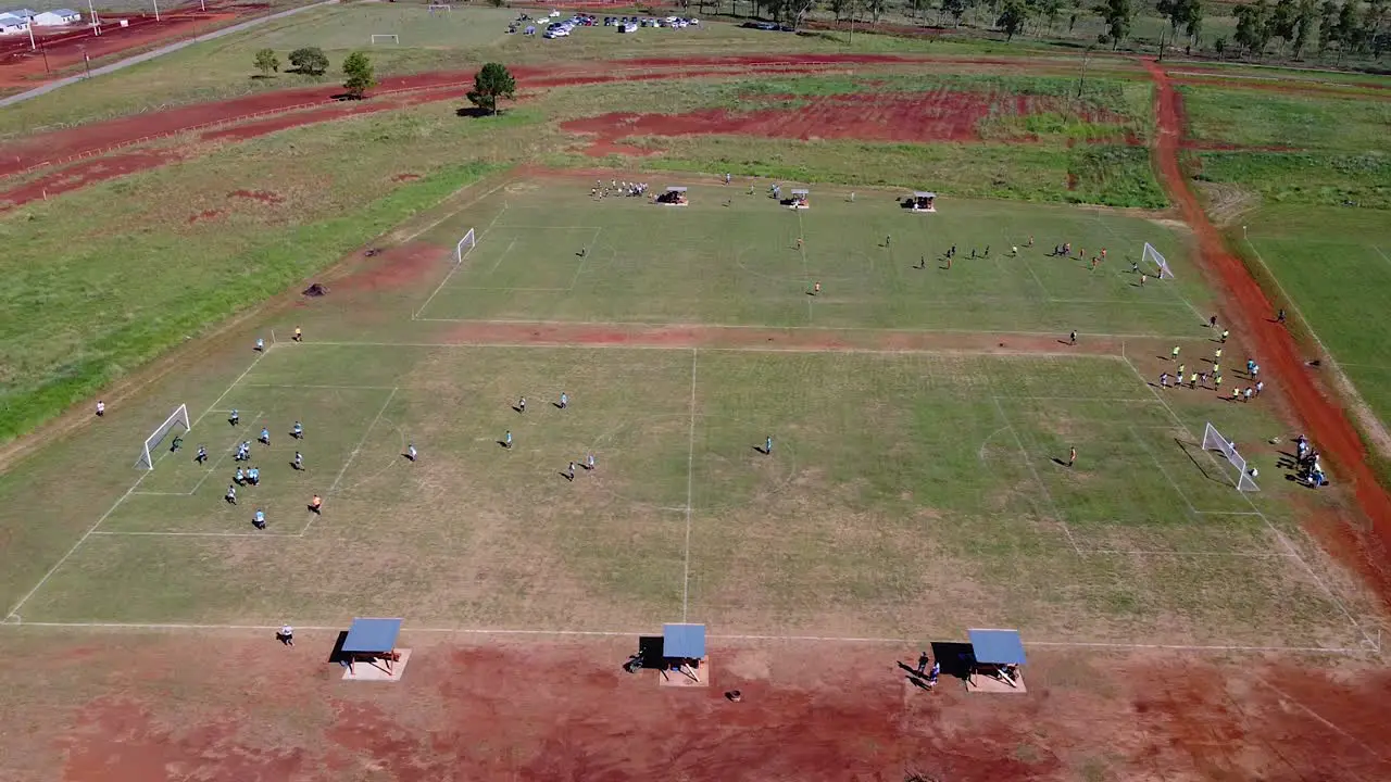 Droen strafe past two football pitches with active energenic footbal matches goalie defends goal