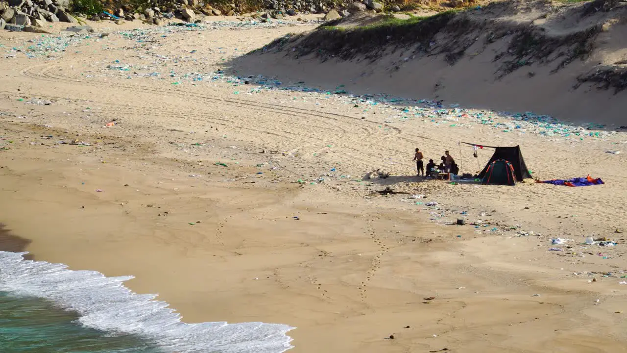 Local people enjoy summer holiday on polluted beach of Binh Hung with tent