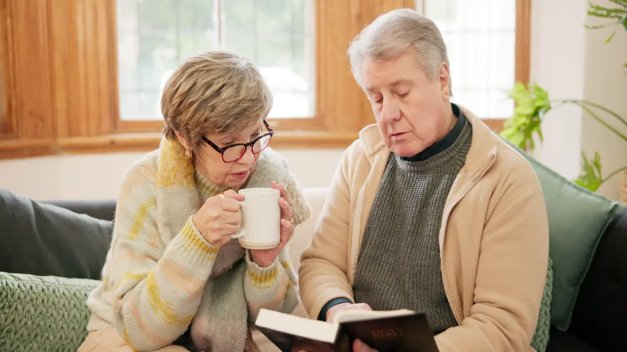 Coffee bible and senior couple on sofa in home