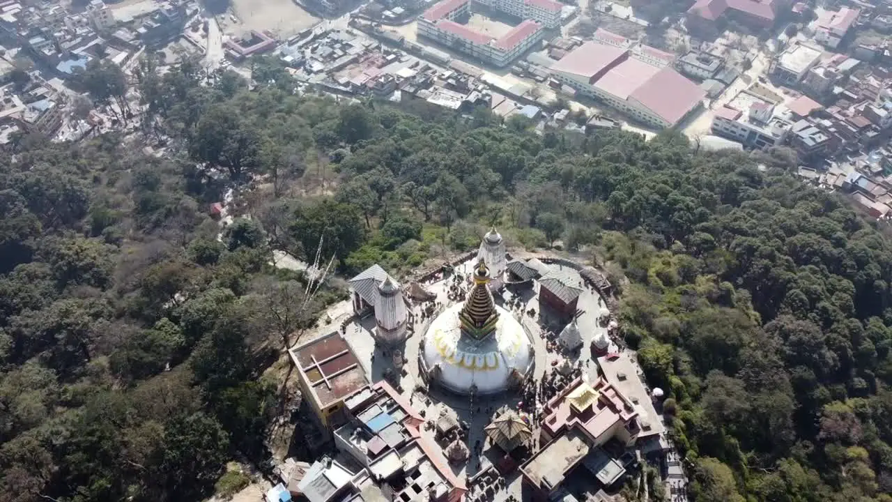 A rising spiral view of the Swayambhunath Stupa on the top of a hill in the city of Kathmandu Nepal