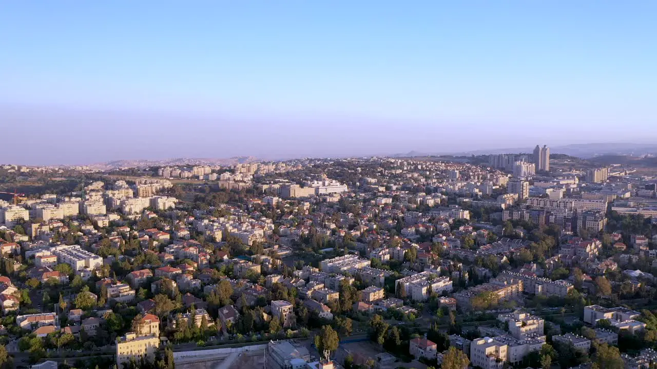 Slow aerial fly over Jerusalem city Israel purple haze day over the buildings