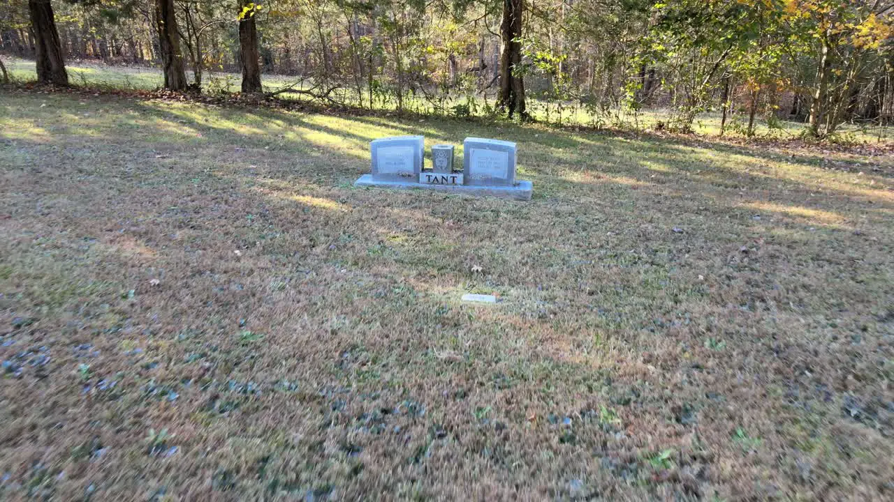 Reverse shot revealing several tombstones at a cemetery