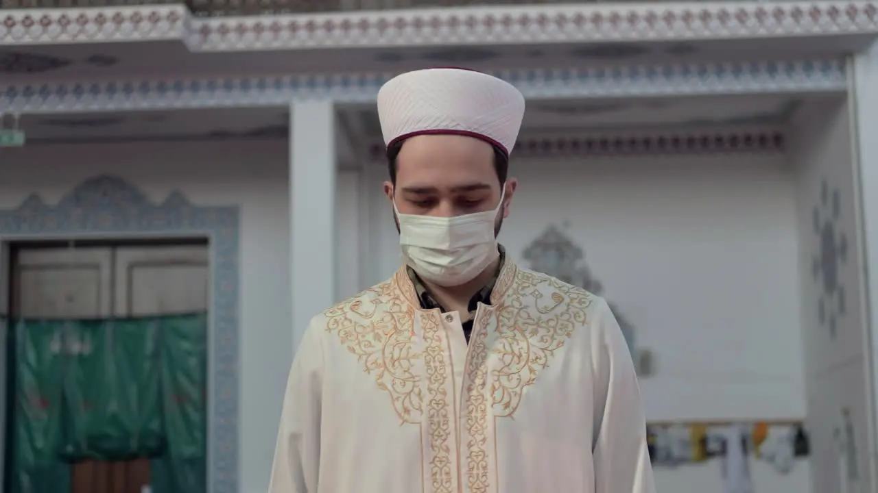 Masked Muslim Imam Praying In Mosque