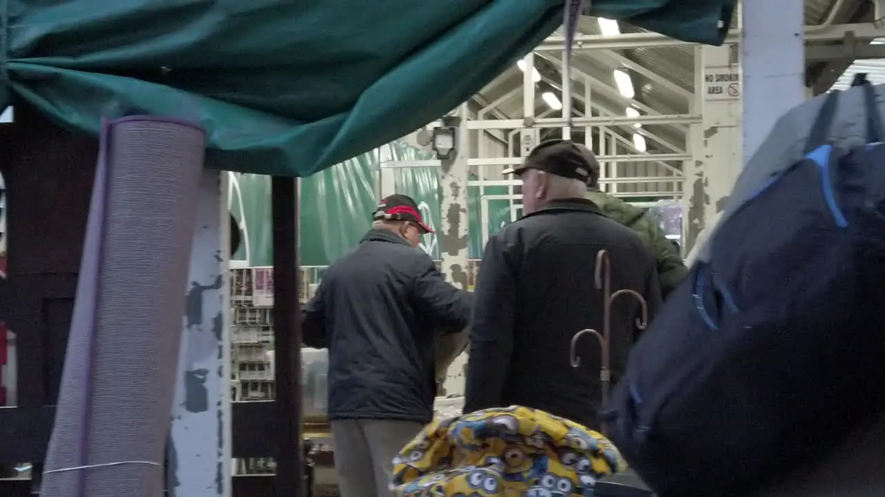 People purchasing second hand objects at flea market uk antique junk fair