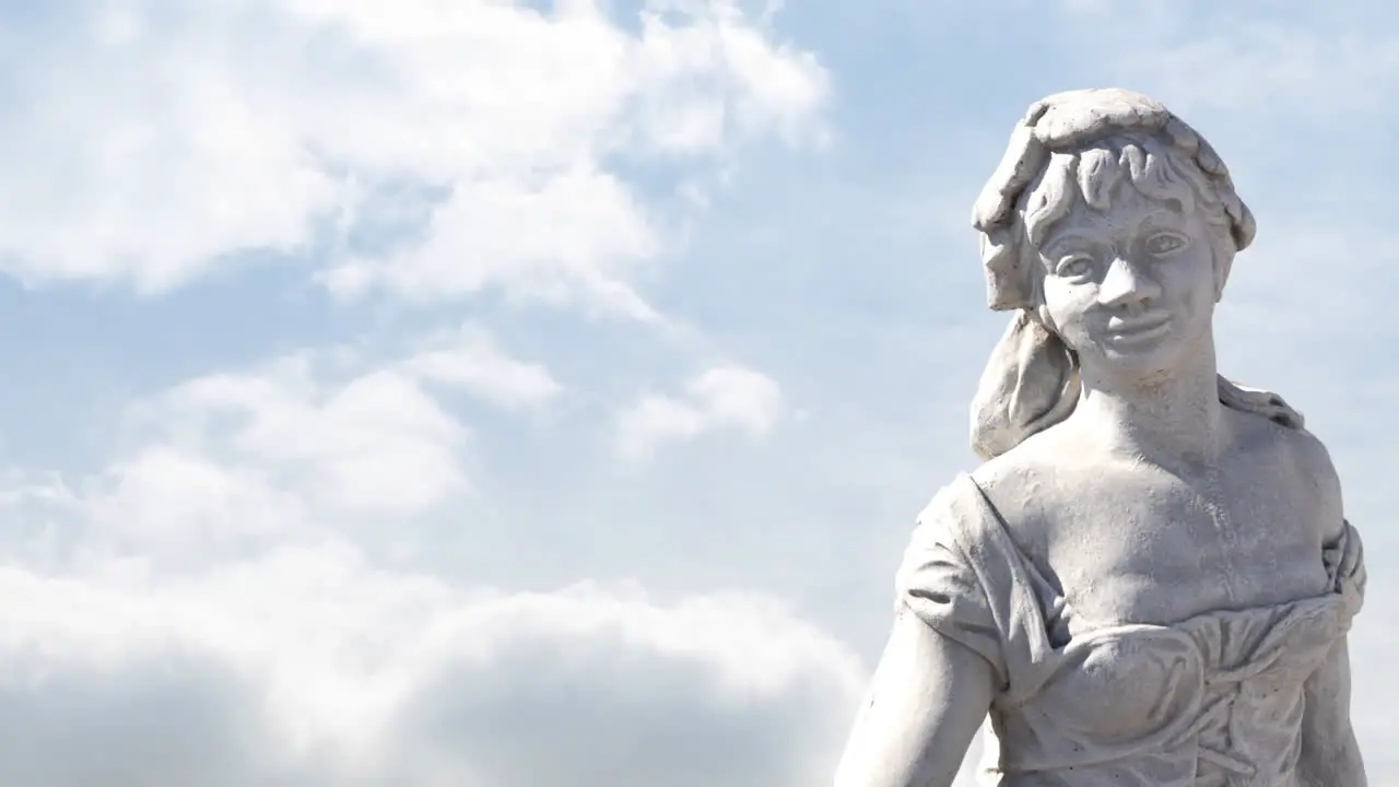 Animation of gray sculpture of woman over blue sky and clouds copy space