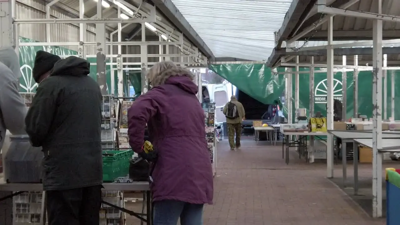 People searching vintage goods at flea market uk antique junk fair