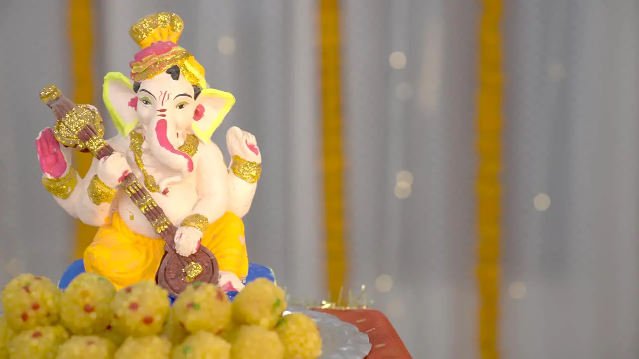 Revealing shot of Ganesh ji sitting in a Thali