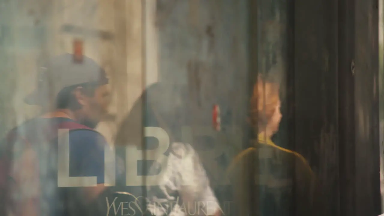 Window reflecting people walking on the street