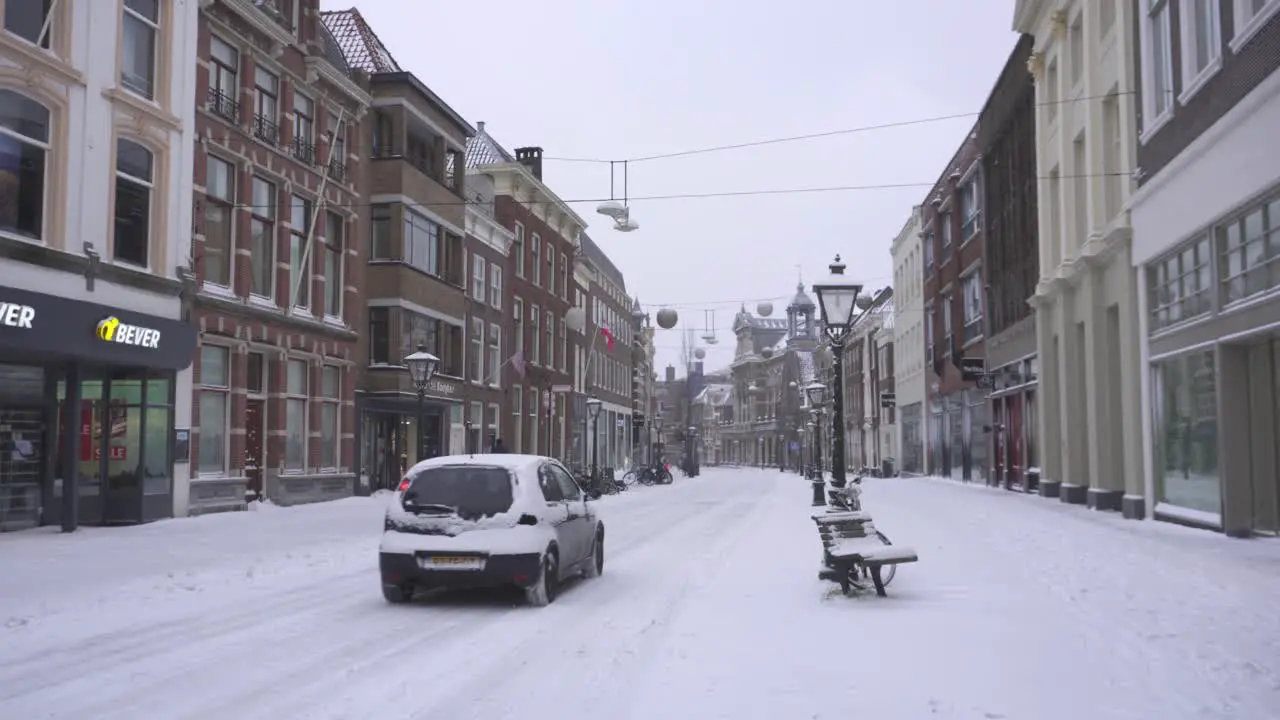 Leiden city buildings and Breestraat road covered in winter snow Netherlands