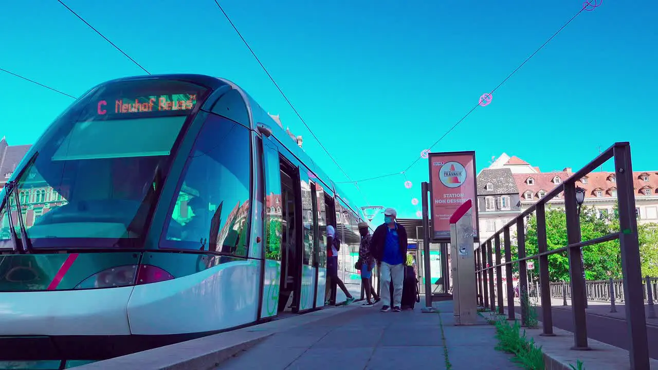 Passengers are getting on and off a tram on Pont Royal near Gallia university residence in Strasbourg Alsace France