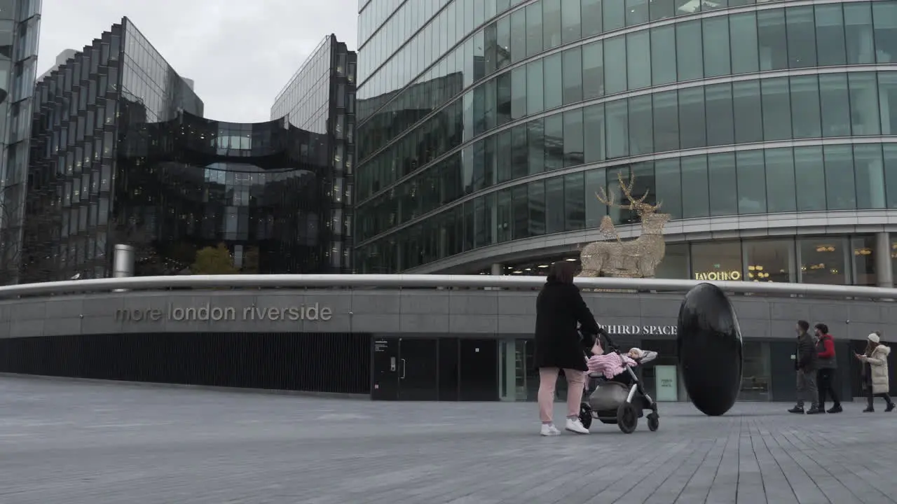 Women Pushing Pram Past More London Riverside During Lockdown