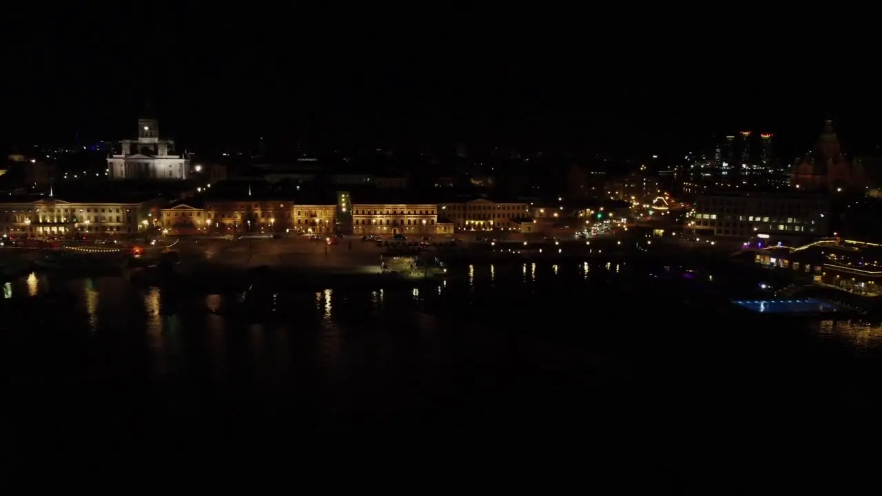 Low waterfront aerial Helsinki City Hall waterfront on black night