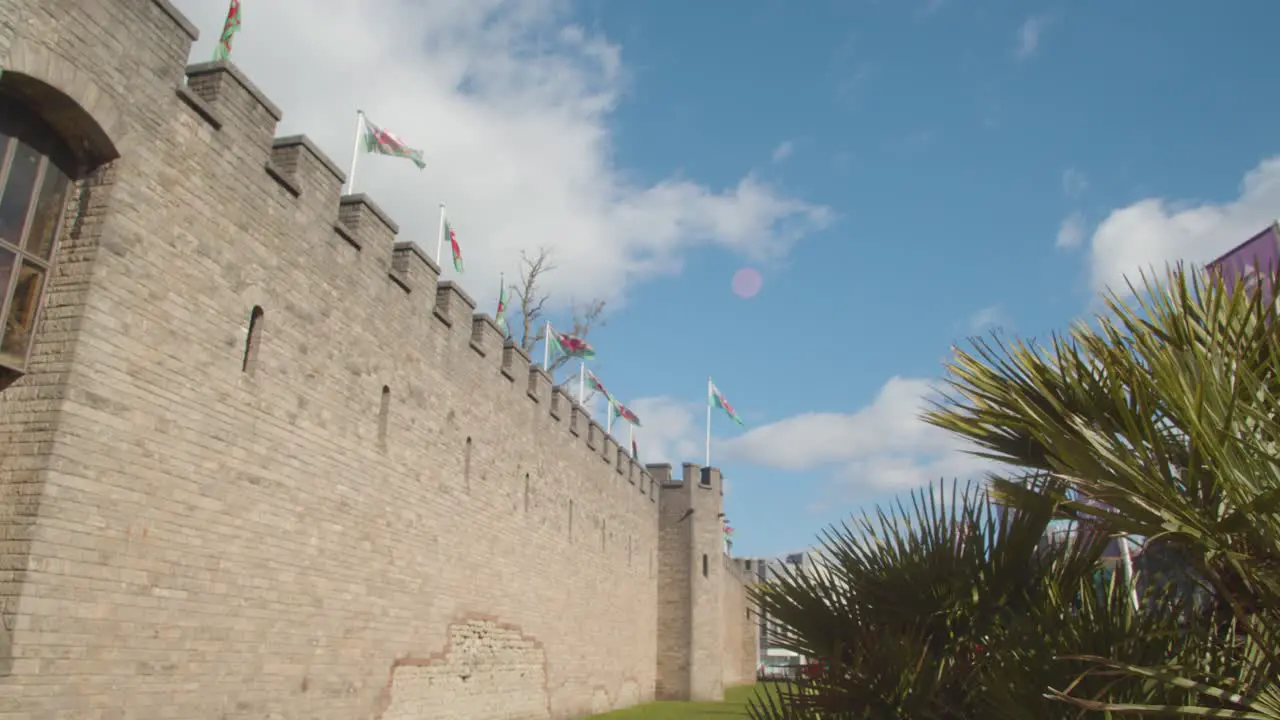 Welsh Flags Flying From Cardiff Castle Against Blue Sky