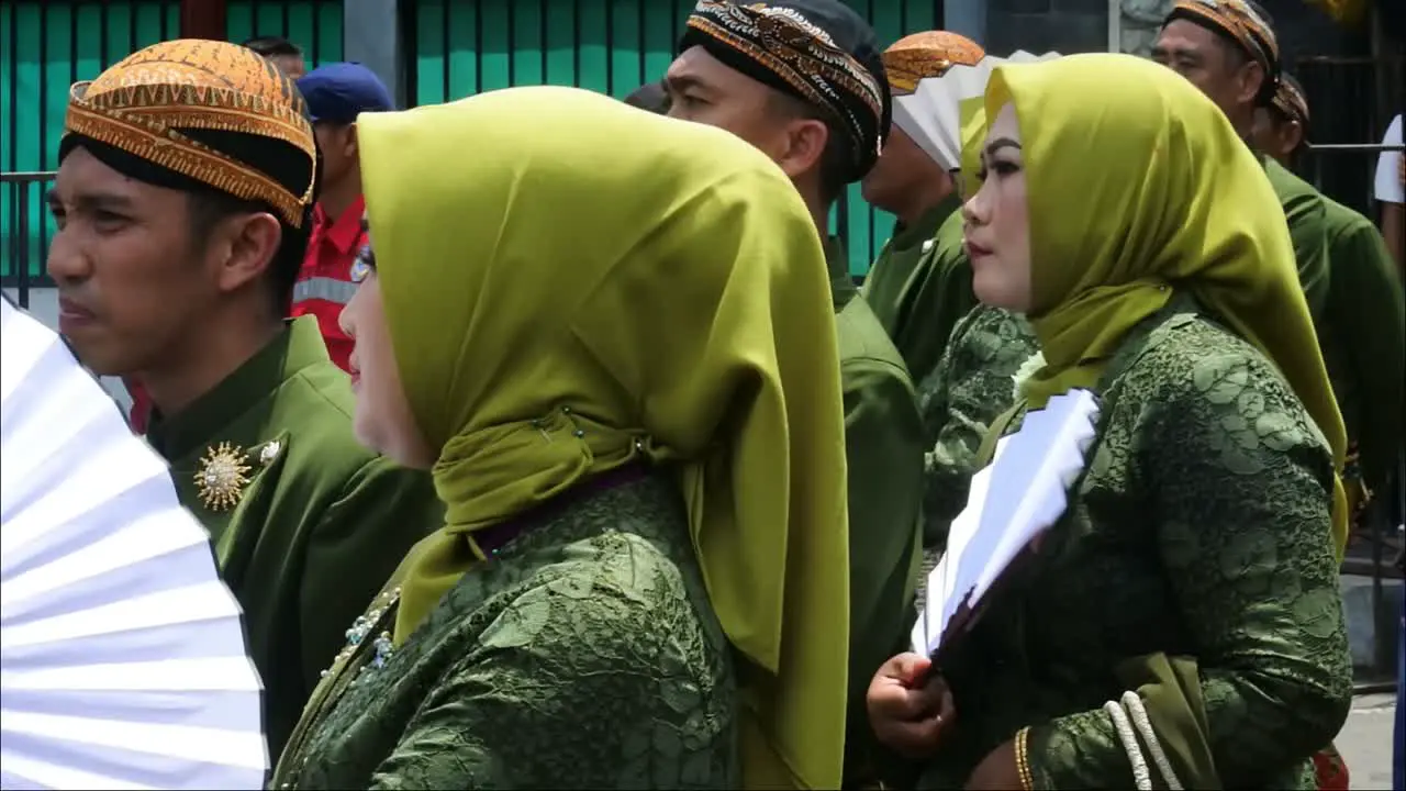 Women and men dressed in traditional Javanese uniform in dance parade