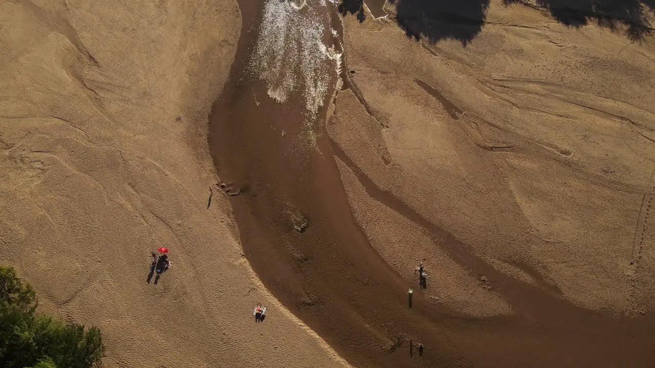 People relaxing on sandy river shore Cordoba in Argentina