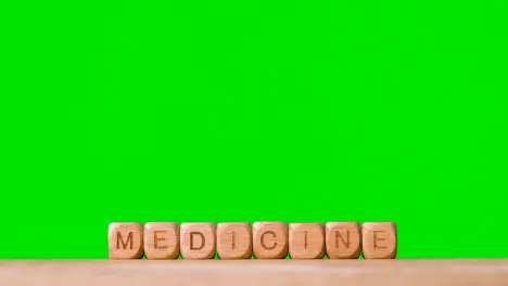 Medical Concept With Wooden Letter Cubes Or Diabetes Spelling Medicine Against Green Screen