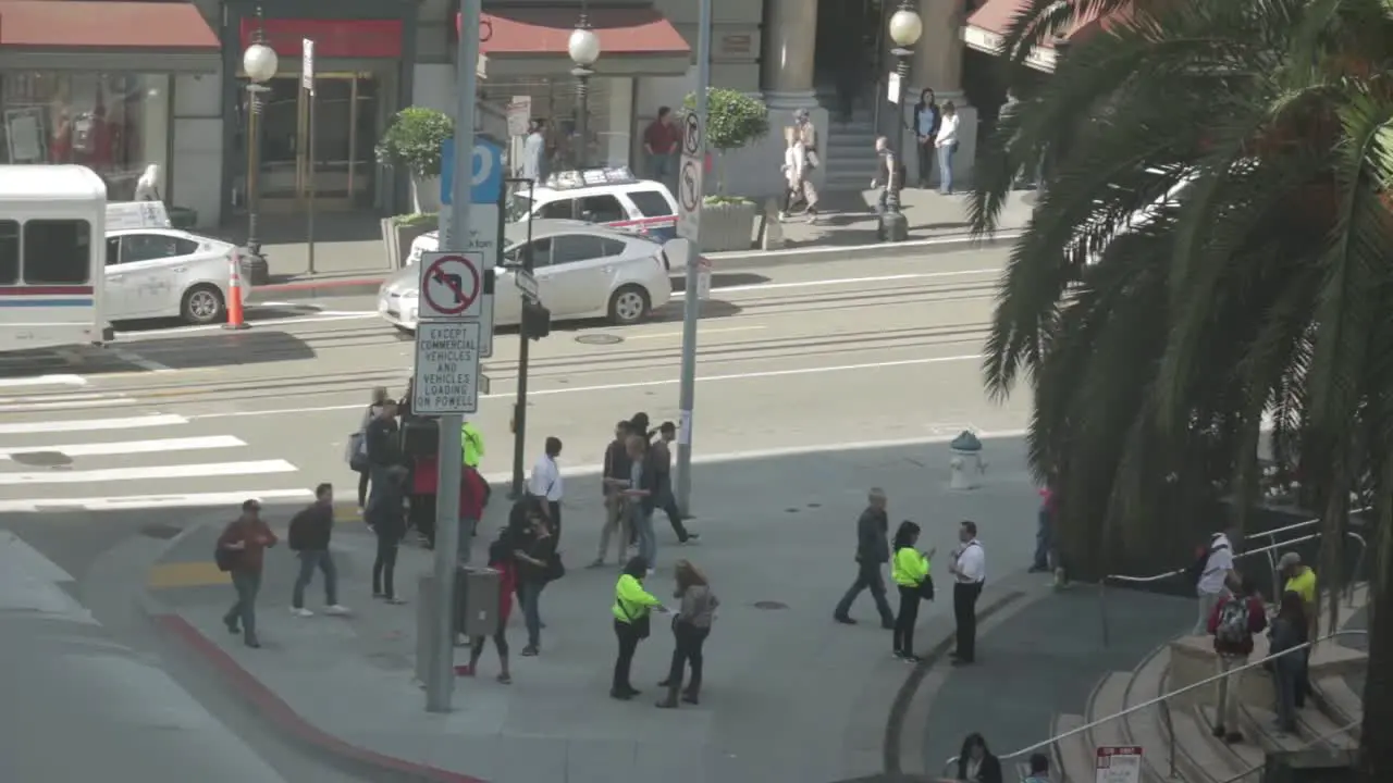 fast time-lapse of people walking the crowded streets of San Francisco while cars pass by