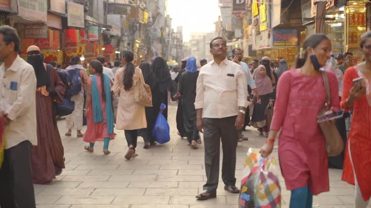 Indian people travelling and shopping across the streets of Charminar Jewellery market slow motion