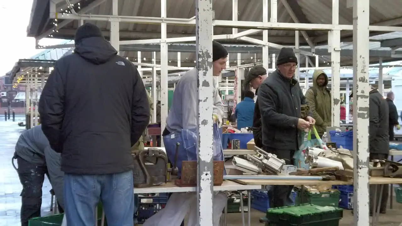 People browsing scrap tools at flea market uk antique junk fair