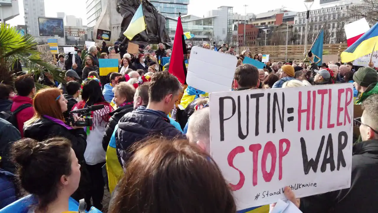 Crowd of people at Ukraine anti war protest demonstration on Manchester city street