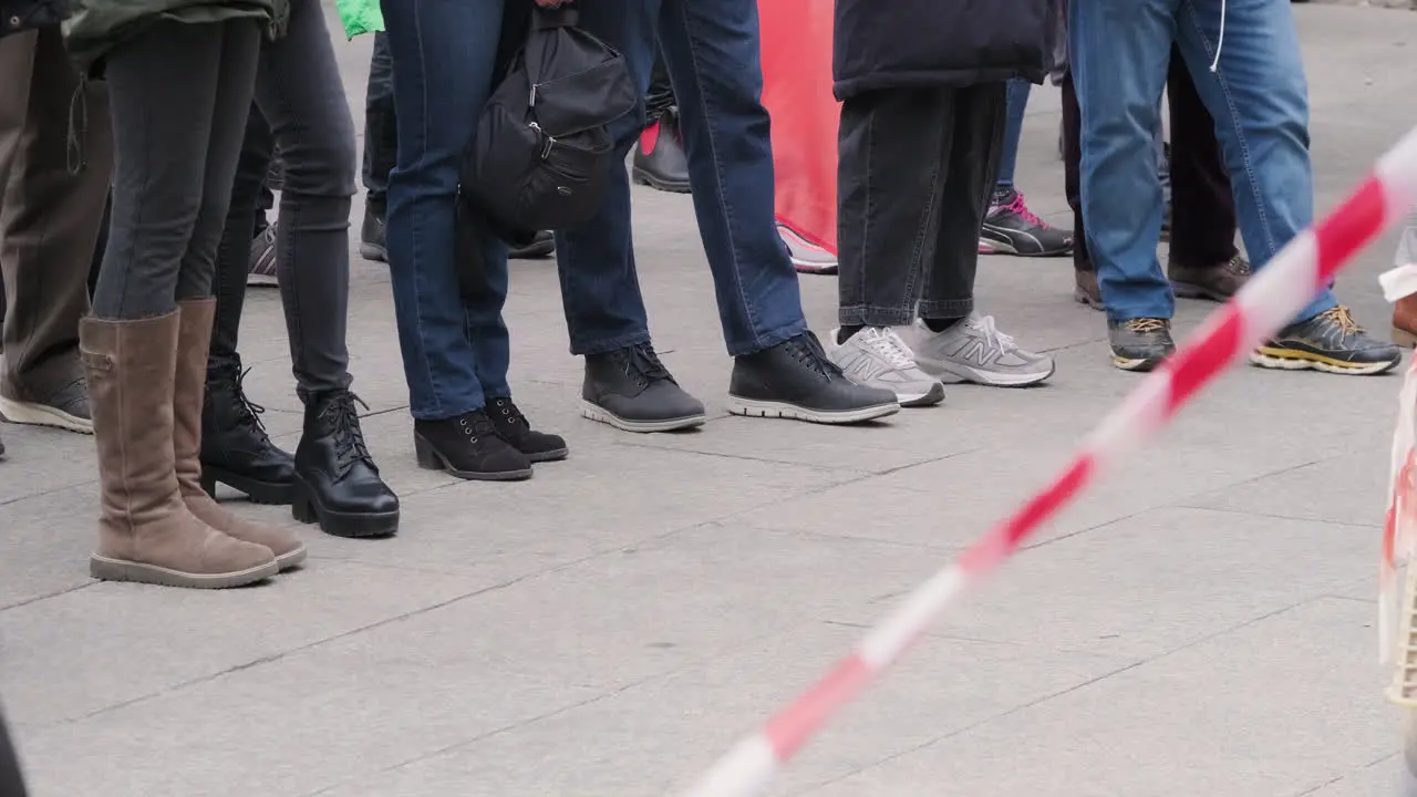 Feet Of Protesters Standing In Restricted Area With Barriers