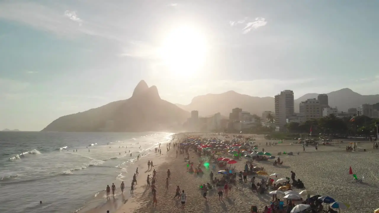 Drone flies above people playing beach soccer and sunbathing in Copacabana Rio de Janeiro Brazil