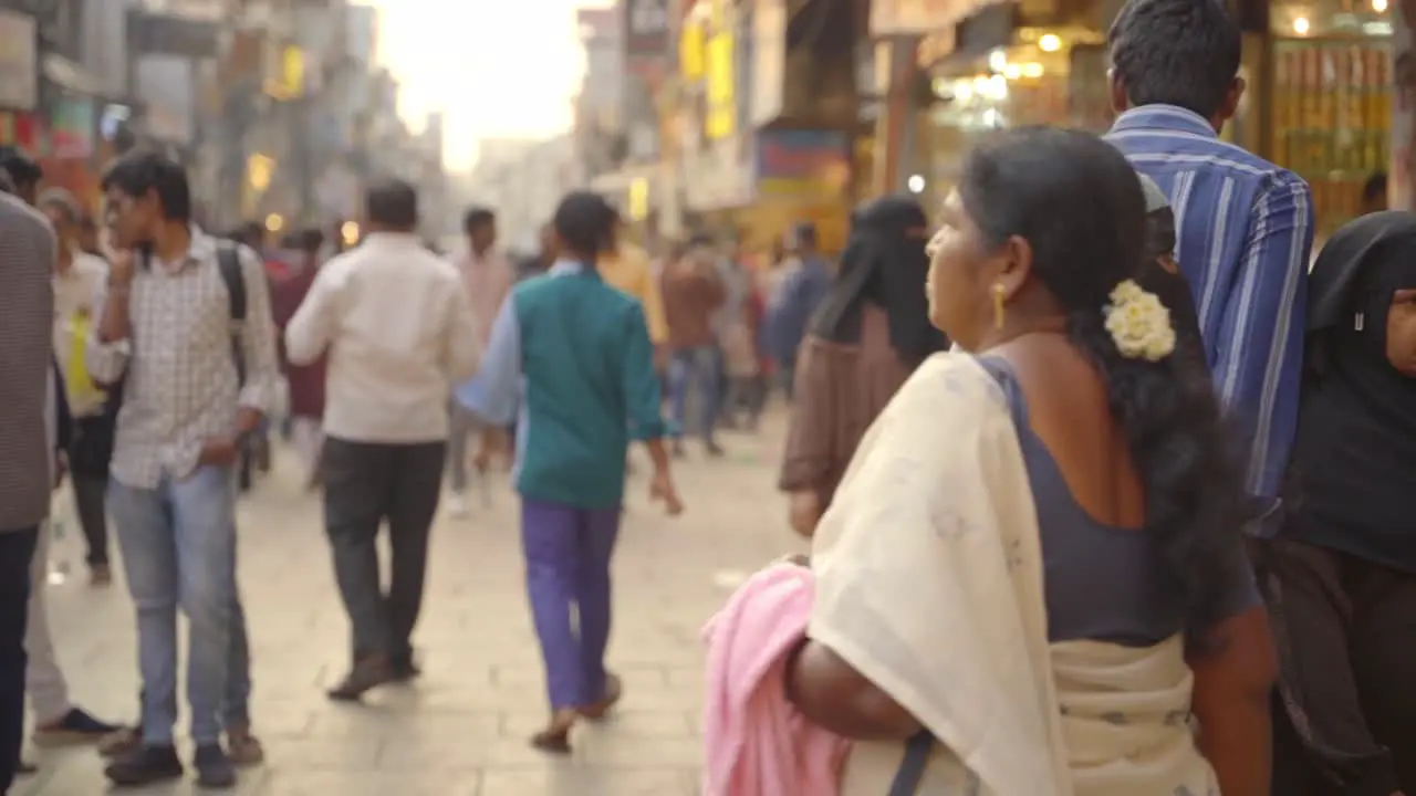 Indian people travelling and shopping across Charminar Jewellery market women wearing traditional hijab burka and fully covered slow motion