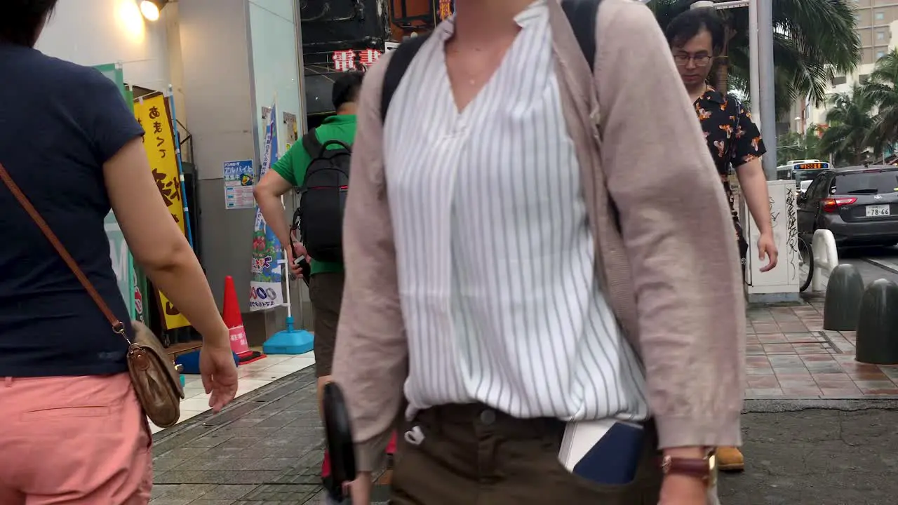 Japanese Shoppers Walking Along the Sidewalk at Popular Shopping Street Kokusai-Dori Naha Okinawa