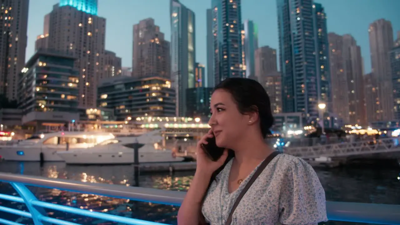 Teenage girl talking on smartphone in Dubai Marina