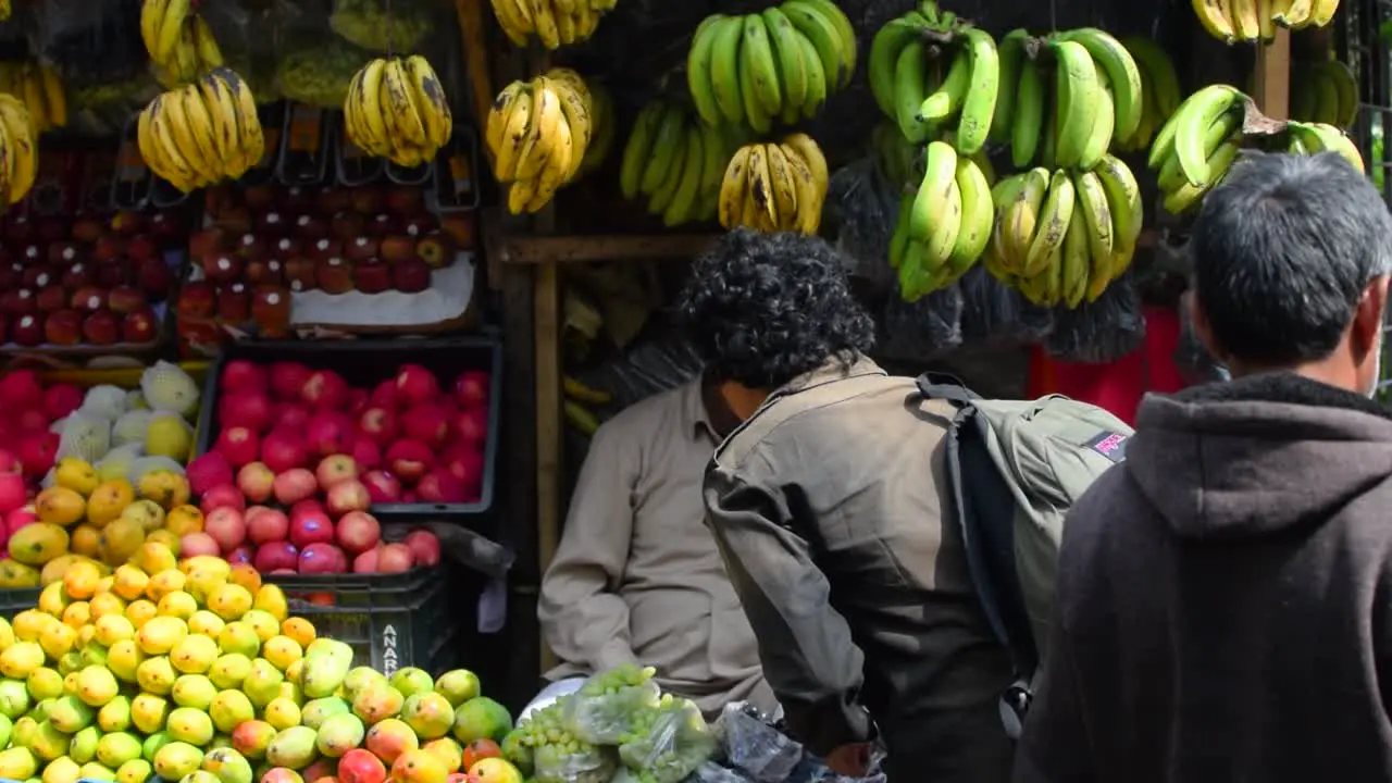 An Indian woman purchasing fruits from the seller from the street stalls of Darjeeling